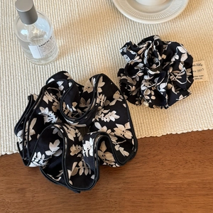 Set of two black and white floral print scrunchies in oversized and standard sizes