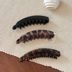 Three-piece banana hair clip set in solid black and tortoise shell patterns for high ponytails