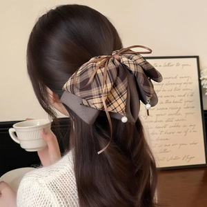 Elegant brown plaid bow hair claw clip with pearl pendants shown on a ponytail style