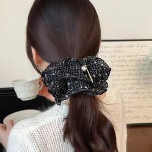 Exquisite tweed knit scrunchie with gold accent and pearl charm on messy bun style