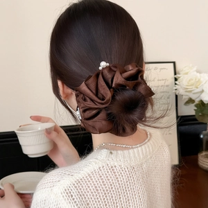 Elegant dark brown satin scrunchie with white pearls on a hair bun stylish look