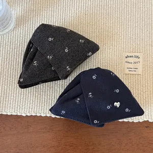 Floral print triangular hair claw clips in navy and grey with heart pendant detail