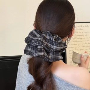 Classic black and white checkered oversized scrunchie styled on a brunette ponytail