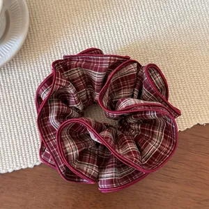 Macro shot of red plaid scrunchie with layered ruffles and delicate overlock edge