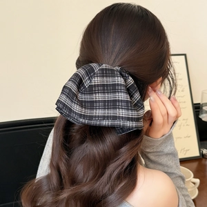 Elegant black and white plaid bow hair clip for ponytail on long brunette wavy hair