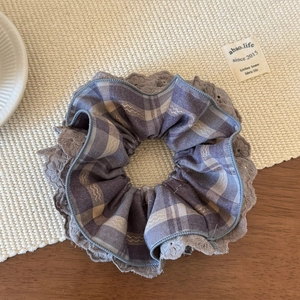 Detail of four-layer lace plaid scrunchie in grey-brown cotton with embroidery edge