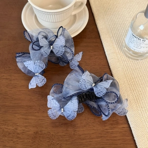 Detailansicht der rauchblauen Organza-Schmetterlingshaarklammern mit Strasssteinen