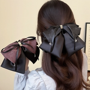 Elegant satin bow hair claw clip with crystal rhinestones for a sophisticated hairstyle