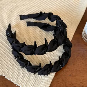Elegant black beaded twisted headband with chic rivets and non-slip design for women