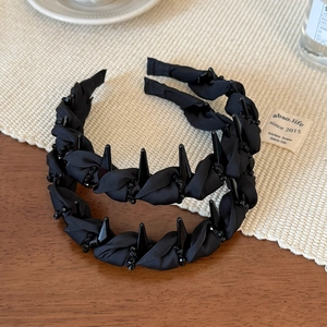 Detail of black beaded twist headband featuring a punk style with anti-slip design and spikes