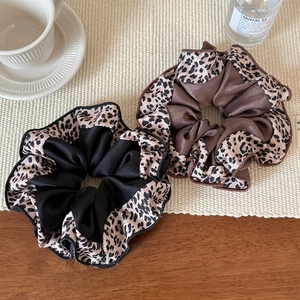 Elegant leopard print scrunchies in silk-like fabric with a stylish mixed pattern design