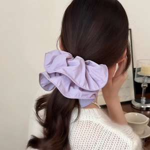 Elegant lavender ruffled oversized scrunchie hair tie shown in a lifestyle ponytail style