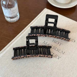 French vintage leopard print acetate hair claw clips set on neutral textured background