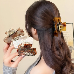 Elegant hollow acetate claw clip set in amber and pearl white for stylish hair styling
