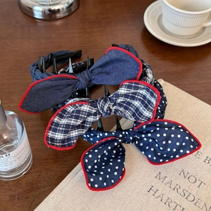 Three-piece set of rabbit ear headbands with red stitched edges and mini hair claw clips