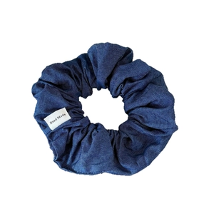 Deep blue denim scrunchie with pleated texture and Hand Made fabric label for hair