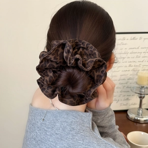 Retro oversized leopard print scrunchie for women styled in a hair bun with soft chiffon fabric