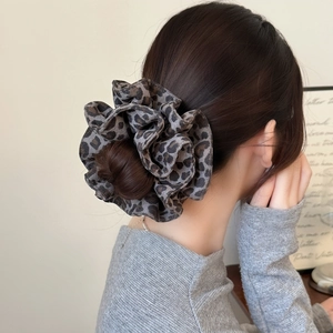 Retro oversized leopard print hair scrunchie shown styled on a high hair bun for women