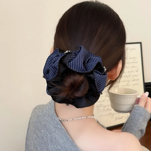 Navy blue striped scrunchie with rhinestones on a low bun hair style for women