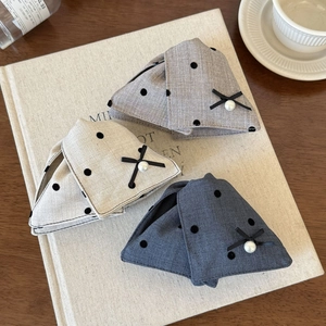 Polka dot fabric bow hair clips with pearls shown in an elegant lifestyle setting