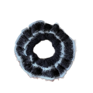 Chic hand-woven knit scrunchie with soft black and light blue fuzzy textures for hair