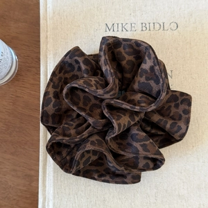 Detail of vintage leopard print scrunchie with velvety texture and pleated edges