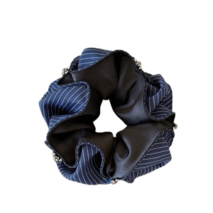 Luxurious rhinestone-edged striped scrunchie in deep blue and black fabric