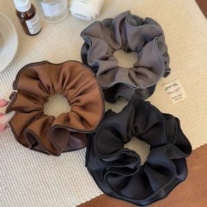 Three-piece set of large striped pleated scrunchies in black, grey, and brown fabric