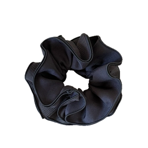 Large black ruffled scrunchie with white pinstripes on a white background