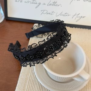 Elegant black lace headband with sequins and beads for a vintage high crown hair look