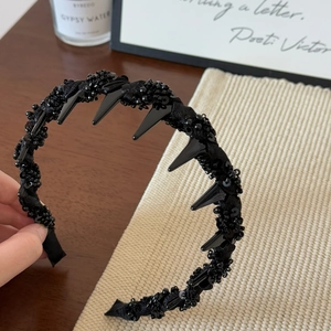 Elegant black beaded headband with chic spikes and sequins in a vintage luxury style