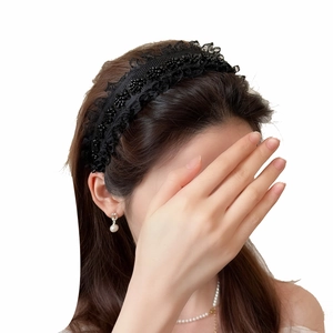 Elegant black lace headband with bead details for a vintage style hair accessory