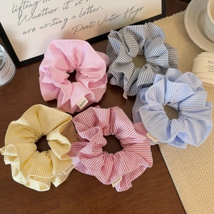 Five-piece set of striped fabric scrunchies in pastel colors with handmade labels