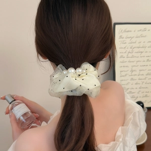Elegant polka dot mesh scrunchie with pearl detail on a ponytail hairstyle