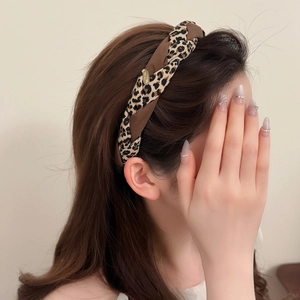 Stylish leopard print silk hairband for women with decorative gold metal plaque detail