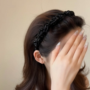 Elegant black woven beaded headband with glossy pearls for a high cranial top hairstyle