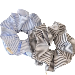 Striped fabric scrunchie set in light blue and black patterns with Hand Made label