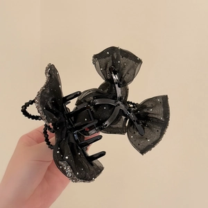 Elegant black mesh bow hair claw clip with shimmering rhinestones and bead chain detail