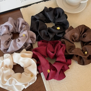 Elegant satin hair scrunchies set in five colors with golden metal logo tags