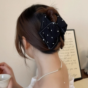 Elegant black denim bow hair claw clip with white heart pattern for women's hairstyles