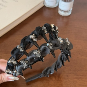 Close-up of punk style mesh headband with sparkling rhinestones and sharp black teeth detail