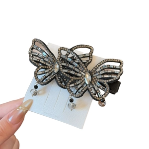Sparkling butterfly hair clip with rhinestones and crystals on fabric base with tassels
