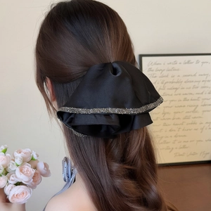 Elegant black satin bow hair claw clip with glitter trim for women's half-up hairstyles
