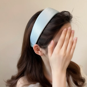 Light blue padded satin headband with elegant matte texture for hair styling