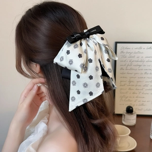 Elegant white camellia bow hair clip with black ribbon for women's hairstyle styling