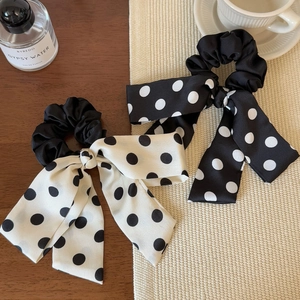 French style polka dot bow hair scrunchies with long streamers on a wooden table