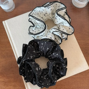 Two-piece floral oversized scrunchie set in black and white print on a book background