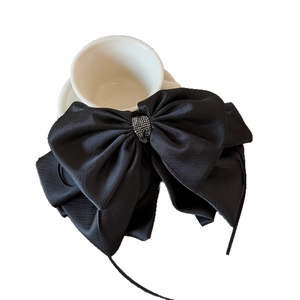 Elegant large black bow hair clip with silver rhinestones and long silk ribbons for women