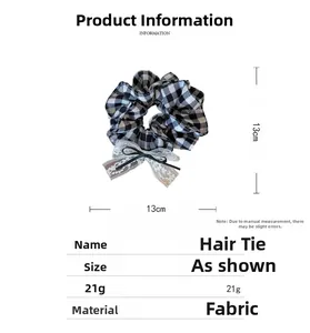 Detail eines 13cm schwarz-weiß karierten Stoff-Scrunchies mit Spitzen-Schleife