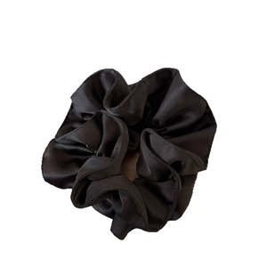 Elegant large black satin scrunchie with soft pleated texture and silky gloss for women